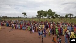 Refugees wait in line to receive packages of food that had been air-dropped by the World Food Programme (WFP) in South Sudan. 