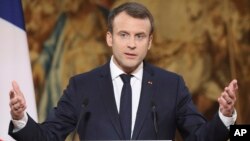 FILE - French President Emmanuel Macron delivers address at the Elysee Palace in Paris, Jan. 3, 2018. 