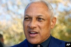 Democrat Mike Espy speaks with reporters after voting in a runoff election, Nov. 27, 2018 in Ridgeland, Miss.