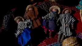Handmade dolls depicting an Uru family lay on a woven textile in the home of Evarista Flores, in the Urus del Lago Poopo indigenous community, in Punaca, Bolivia, Monday, May 24, 2021.