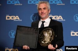 FILE - Alfonso Cuaron, director of "Roma," poses with his medallion after winning the Feature Film category at the Directors Guild Awards in Los Angeles, California, Feb. 2, 2019.