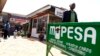 FILE - A man walks away from a retail mobile money transfer shop in Ngong township on the outskirts of Kenya's capital Nairobi.