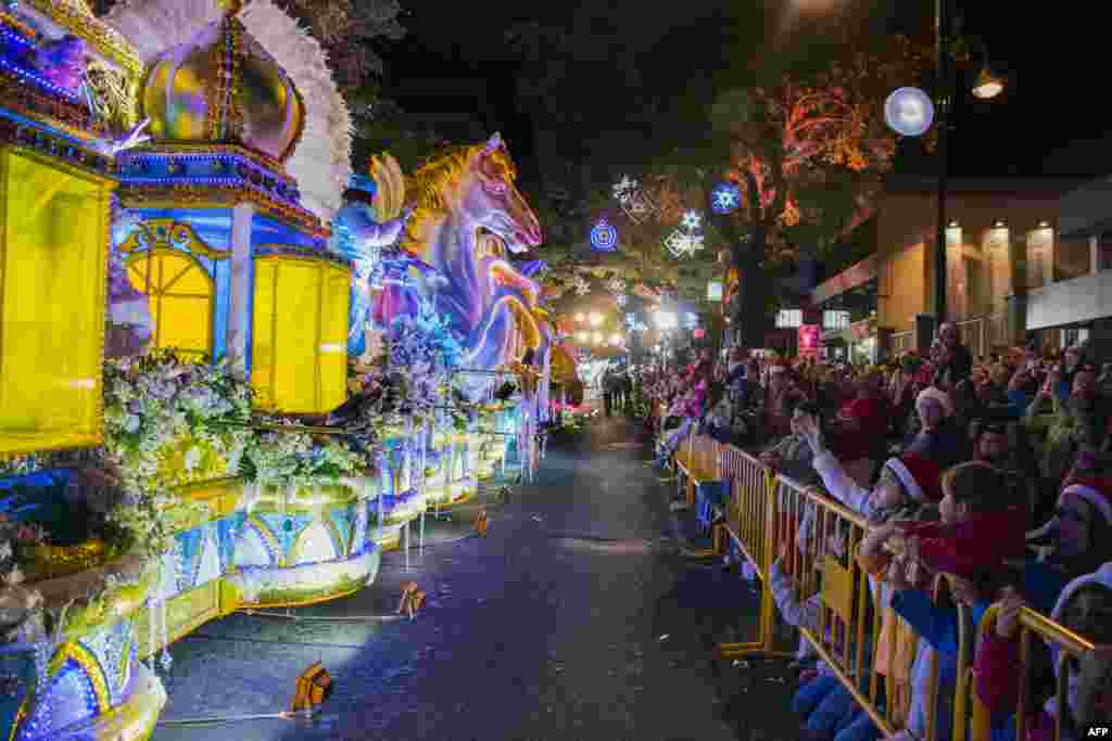 People attend the Light Festival parade in the main streets of San Jose, Costa Rica, Dec. 15, 2018.