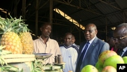 Rwandan central bank governor Claver Gatete visits markets in Kigali. He says regional integration is already a reality, but international efforts could drive down prices, November 1, 2011.