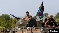 A Ukrainian military convoy moves along a road near Donetsk, Aug. 9, 2014.
