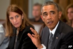 President Barack Obama, right, next to Health and Human Services Secretary Sylvia Burwell, speaks to the media about Ebola during a meeting in the Cabinet Room of the White House, Oct. 15, 2014.