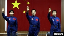 Astronot Tiongkok Jing Haipeng (tengah), Liu Wang (kanan) and Liu Yang, astronot perempuan pertama Tiongkok berhasil kembali ke bumi (29/6) setelah menyelesaikan misi merapatkan Shengzou-9 ke stasiun luar angkasa.