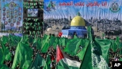 Palestinian Hamas supporters wave green Islamic flags during a rally to mark the 23rd anniversary of the group's founding in Gaza City, 14 Dec 2010