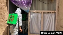 Lashkargah Municipality workers spraying in streets amidst covid19 outbreak