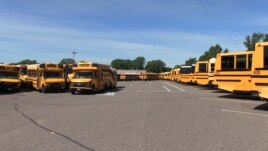 A fleet of Metropolitan Transportation Network buses in a parking lot at the company's headquarters in Fridley, Minnesota, Aug. 10, 2017.