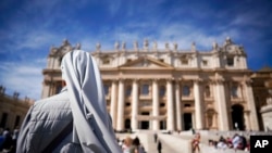 FILE - A nun waits for the arrival of Pope Francis for his weekly general audience, in St. Peter's Square at the Vatican, Sept. 26, 2018. A global organization of nuns has denounced the "culture of silence" surrounding sexual abuse of sisters.