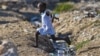 A girl jumps over an open sewage in Port-au-Prince, Sept. 4, 2012.