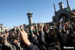 FILE - Supporters of the Iranian opposition movement wear green during the funeral of Grand Ayatollah Hossein Ali Montazeri in the holy city of Qom Dec. 21, 2009.