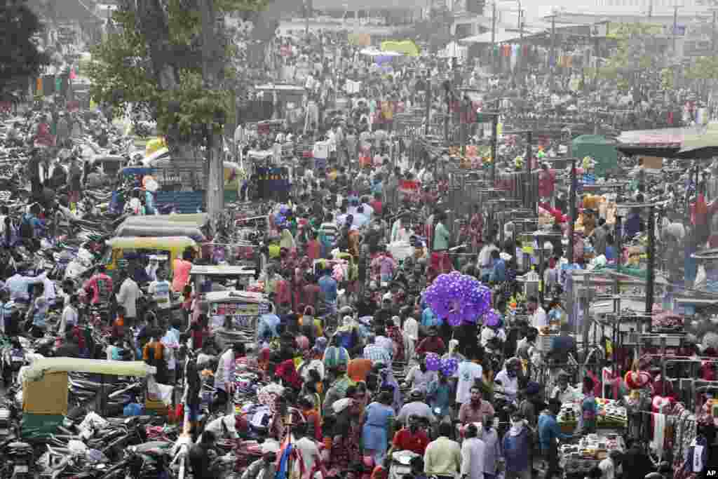 Indians crowd a market for shopping ahead of Hindu festival Diwali in Ahmedabad, India.