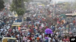 Indians throng a market for shopping ahead of Hindu festival Diwali in Ahmedabad, India, Thursday, Nov. 12, 2020.