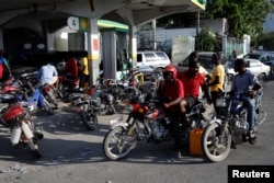 Motorbike and car drivers wait to get fuel at a gas station in Port-au-Prince, Haiti, April 7, 2019. Picture taken April 7, 2019.