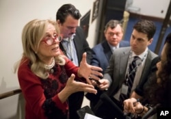 Rep. Debbie Dingell, D-Mich. (L) responds to reporters after members of the House Democratic Caucus met on Capitol Hill in the wake of reports of sexual misconduct by Rep. John Conyers, D-Mich., the longest-serving member of the House, in Washington, Nov.