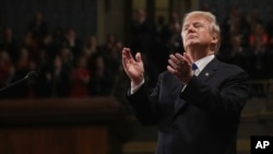 President Donald Trump claps at his first State of the Union address in the House chamber of the U.S. Capitol to a joint session of Congress, in Washington, Jan. 30, 2018.