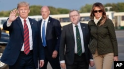 President Donald Trump and first lady Melania Trump on the tarmac during their arrival on Air Force One at Glasgow Prestwick Airport in Scotland, July 13, 2018. Secretary of State for Scotland, United Kingdom, David Mundell, second from right, greeted them.