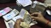 India's Currency Plunges to Record Low