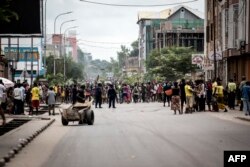 FILE - Protesters sing and dance during a demonstration calling for President Joseph Kabila of the Democratic Republic of the Congo to step down, in Kinshasa, Jan. 21, 2018.