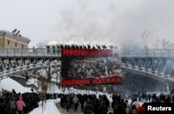 Activists burn flares during a protest against the extension of police authority and power in central Kyiv, Ukraine, Nov. 14, 2016.