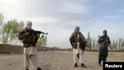 FILE - Members of the Taliban stand in Ghazni province.