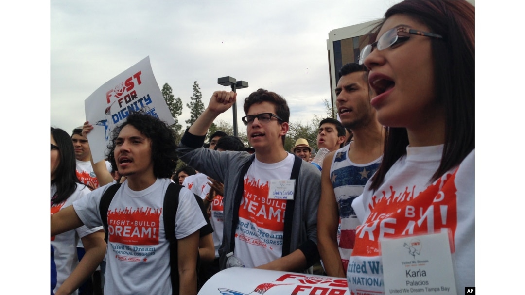 FILE - Youth from United We Dream chant slogans calling for an end to deportations outside the Immigration and Customs Enforcement (ICE) offices in downtown Phoenix, Feb. 22, 2014.