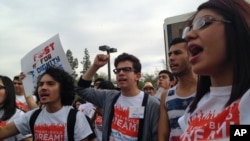 Youth from United We Dream chant slogans calling for an end to deportations. outside the Immigration and Customs Enforcement (ICE) offices in downtown Phoenix, Feb. 22, 2014.