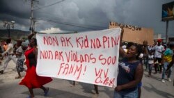 People protest carrying a banner with a message that reads in Spanish: "No to kidnappings, no to violence against women ! Long live Christian Aid Ministries," demanding the release of kidnapped missionaries, in Haiti, Oct. 19, 2021.
