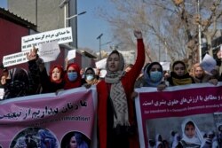 FILE - Afghan women shout slogans during a rally to protest Taliban restrictions on women, in Kabul, Afghanistan, Dec. 28, 2021.