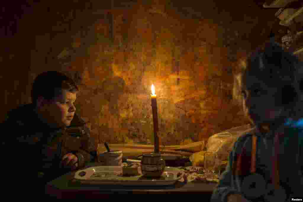 Lazar and his sister Andjelka sit by a candle in their home in the eastern Serbian town of Majdanpek. Electricity workers in Serbia struggled through snow, ice and difficult terrain to restore electricity to an eastern town left without power, heating or running water for a fourth day.