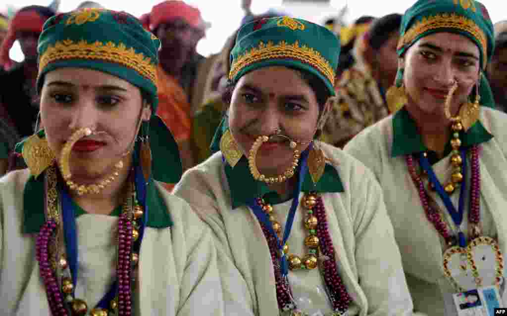 Traditional dancers from Uttrakhand state wait to perform during a press preview of tableaux participating in the forthcoming Republic Day parade in New Delhi, India.