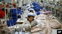 FILE - North Korean workers assemble jackets at a factory of a South Korean-owned company at the jointly run Kaesong Industrial Complex in Kaesong, North Korea, Dec. 19, 2013.