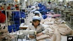 FILE - North Korean workers assemble jackets at a factory of a South Korean-owned company at the jointly run Kaesong Industrial Complex in Kaesong, North Korea, Dec. 19, 2013.