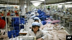 FILE - North Korean workers assemble jackets at a factory of a South Korean-owned company at the jointly run Kaesong Industrial Complex in Kaesong, North Korea, Dec. 19, 2013.