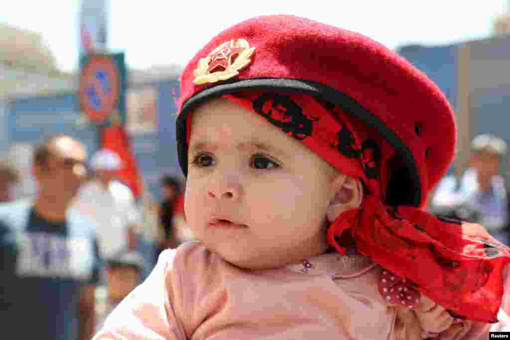 A child attends a march organized by Lebanese Communist party to mark Labour Day in Beirut, May 1, 2015. 