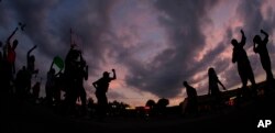 FILE - Angry protestors in Ferguson, Missouri, Aug. 18, 2014.