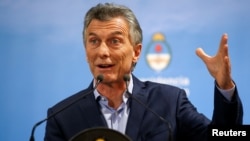FILE - Argentina's President Mauricio Macri gestures during a news conference at the Olivos Presidential Residence in Buenos Aires, May 16, 2018. 