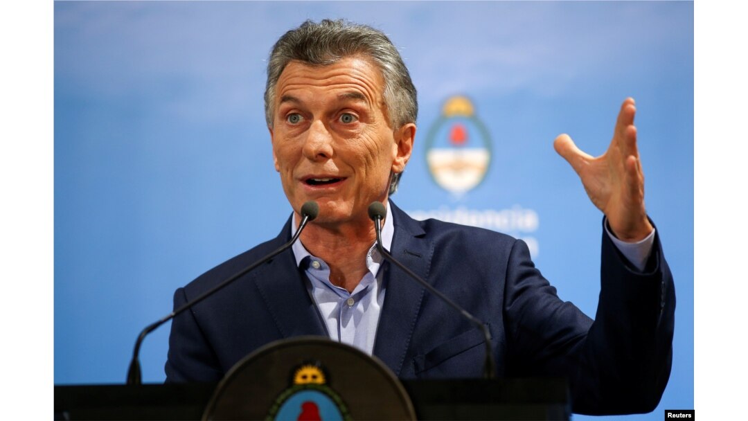 FILE - Argentina's President Mauricio Macri gestures during a news conference at the Olivos Presidential Residence in Buenos Aires, May 16, 2018.