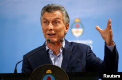FILE - Argentina's President Mauricio Macri gestures during a news conference at the Olivos Presidential Residence in Buenos Aires, May 16, 2018.