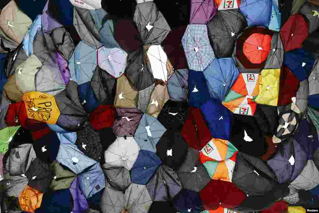 Umbrellas, which have become the symbol of pro-democracy demonstrators, hang between footbridges at the protesters&#39; camp in central Hong Kong, China. 