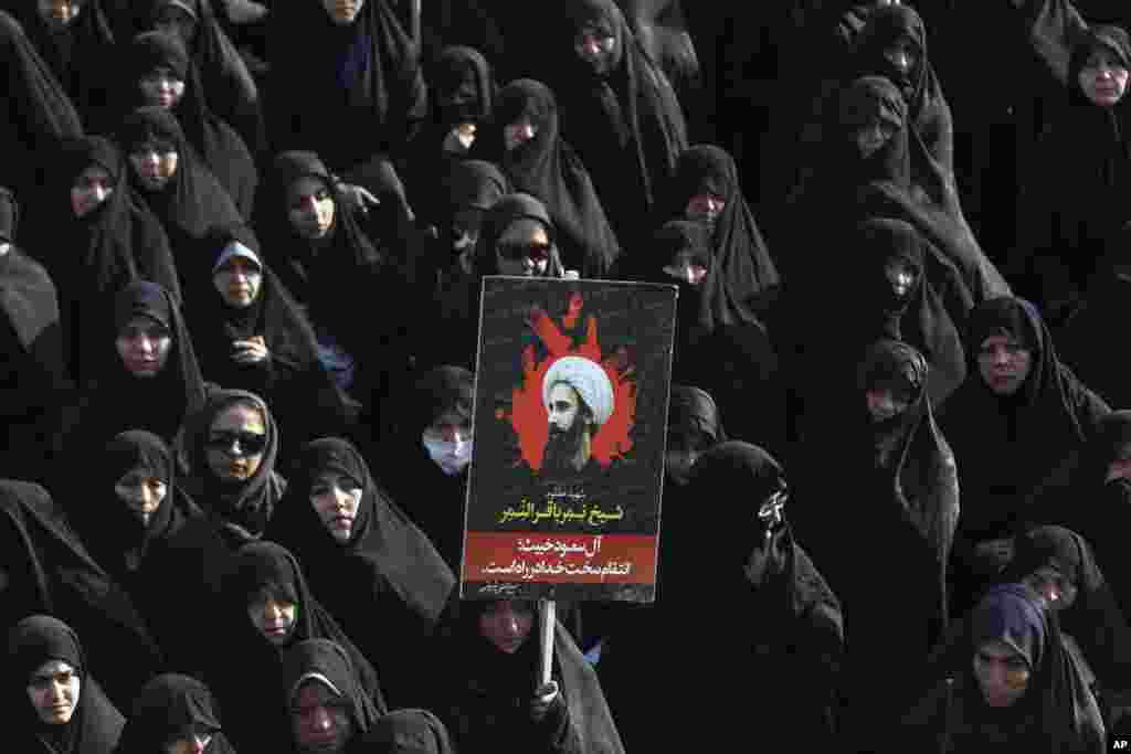 An Iranian woman in Tehran holds up a poster showing Sheikh Nimr al-Nimr, a prominent Shi'ite cleric who was executed last week by Saudi Arabia. Allies of Saudi Arabia followed the kingdom's lead and began scaling back diplomatic ties to Iran after the ransacking of Saudi diplomatic missions in the Islamic Republic, violence sparked by the Saudi execution of al-Nimr.