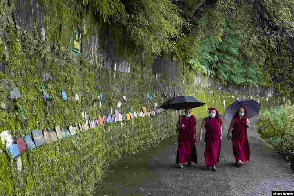 Exile Tibetan Buddhist monks circumambulate the residence of their spiritual leader the Dalai Lama in Dharmsala, India.