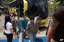 FILE - A group of Salvadoran deportees arrive at La Chacra Immigration Center in San Salvador, El Salvador, June 28, 2018.