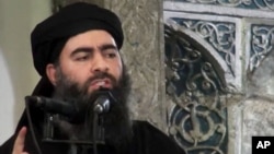FILE - This image taken from a militant website July 5, 2014, purports to show the leader of the Islamic State group, Abu Bakr al-Baghdadi, who released a new message late Wednesday, encouraging his followers to keep up the fight for the city of Mosul.