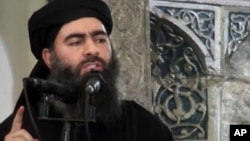 FILE - This image taken from a militant website July 5, 2014, purports to show the leader of the Islamic State group, Abu Bakr al-Baghdadi, who released a new message late Wednesday, encouraging his followers to keep up the fight for the city of Mosul.