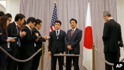 Japanese Prime Minister Shinzo Abe, right center, speaks to members of the press after meeting with President-elect Donald Trump in New York, Nov. 17, 2016.