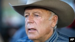 FILE - Rancher Cliven Bundy speaks with supporters at an event, April 11, 2015, in Bunkerville, Nev.