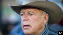 FILE - Rancher Cliven Bundy speaks with supporters at an event, April 11, 2015, in Bunkerville, Nevada.